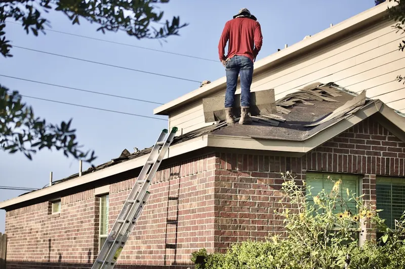 Professional roofer working on a residential roof in Fleming Summit